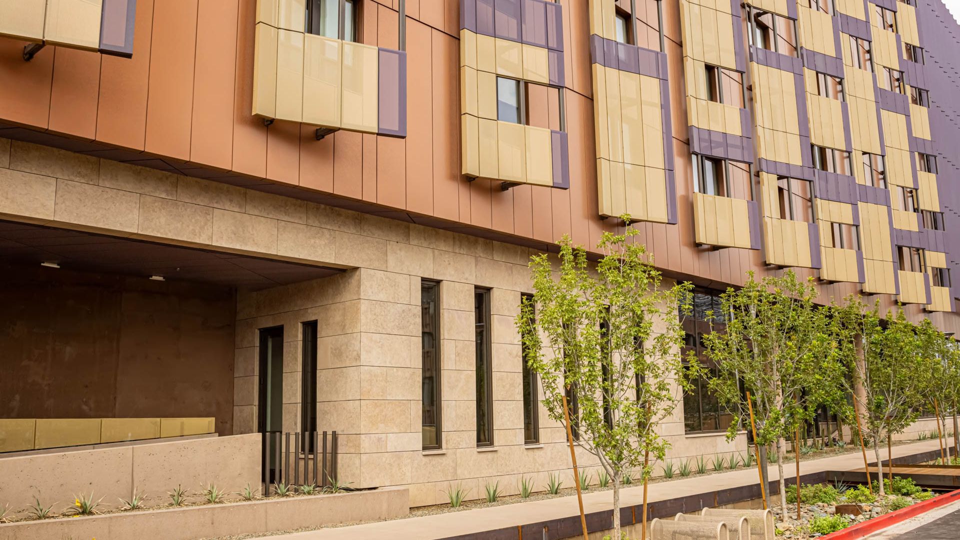 Completed ASU Herberger student housing facade with natural stone installed using Gridworx UXF